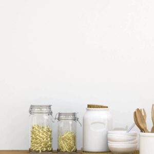 A wooden table with jars and spoons on it