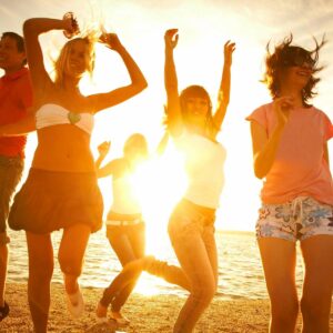 A group of people dancing on the beach