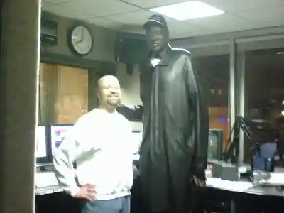 Two men standing in a radio studio.